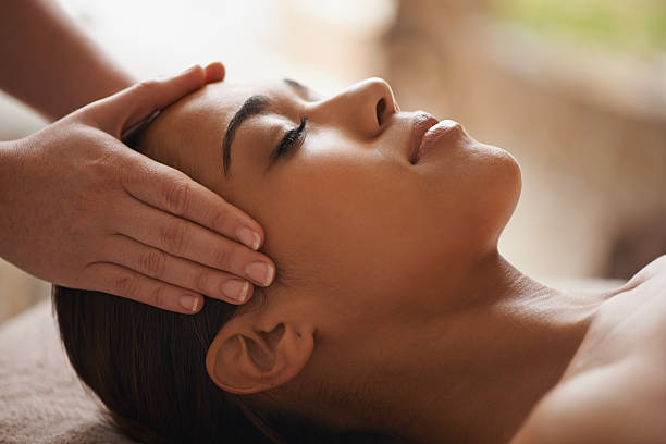 Shot of a beautiful young woman getting a head massage at a spa